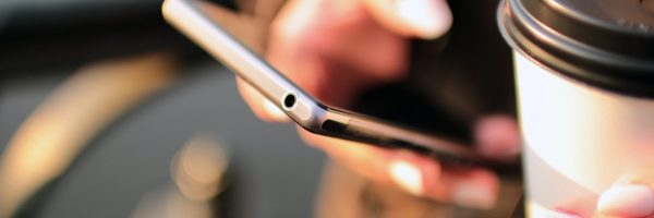 Person using their cell phone to submit a contact form for more information about the NM Real Estate Academy, powered by CNM Ingenuity
